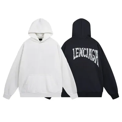 Two hooded sweatshirts, one white and one black with an arched chest print, laid on white