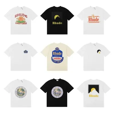 Nine printed t-shirts in white, black and cream arranged in a three by three grid