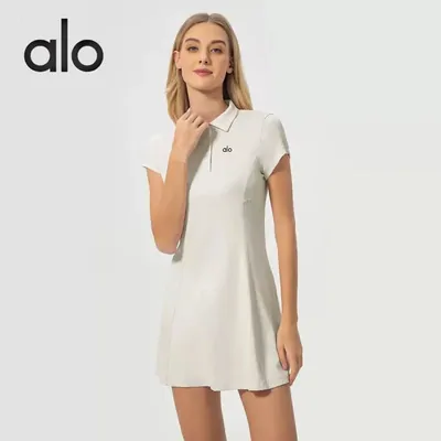 A white short-sleeved tennis dress with a collar, worn by a model on a white background